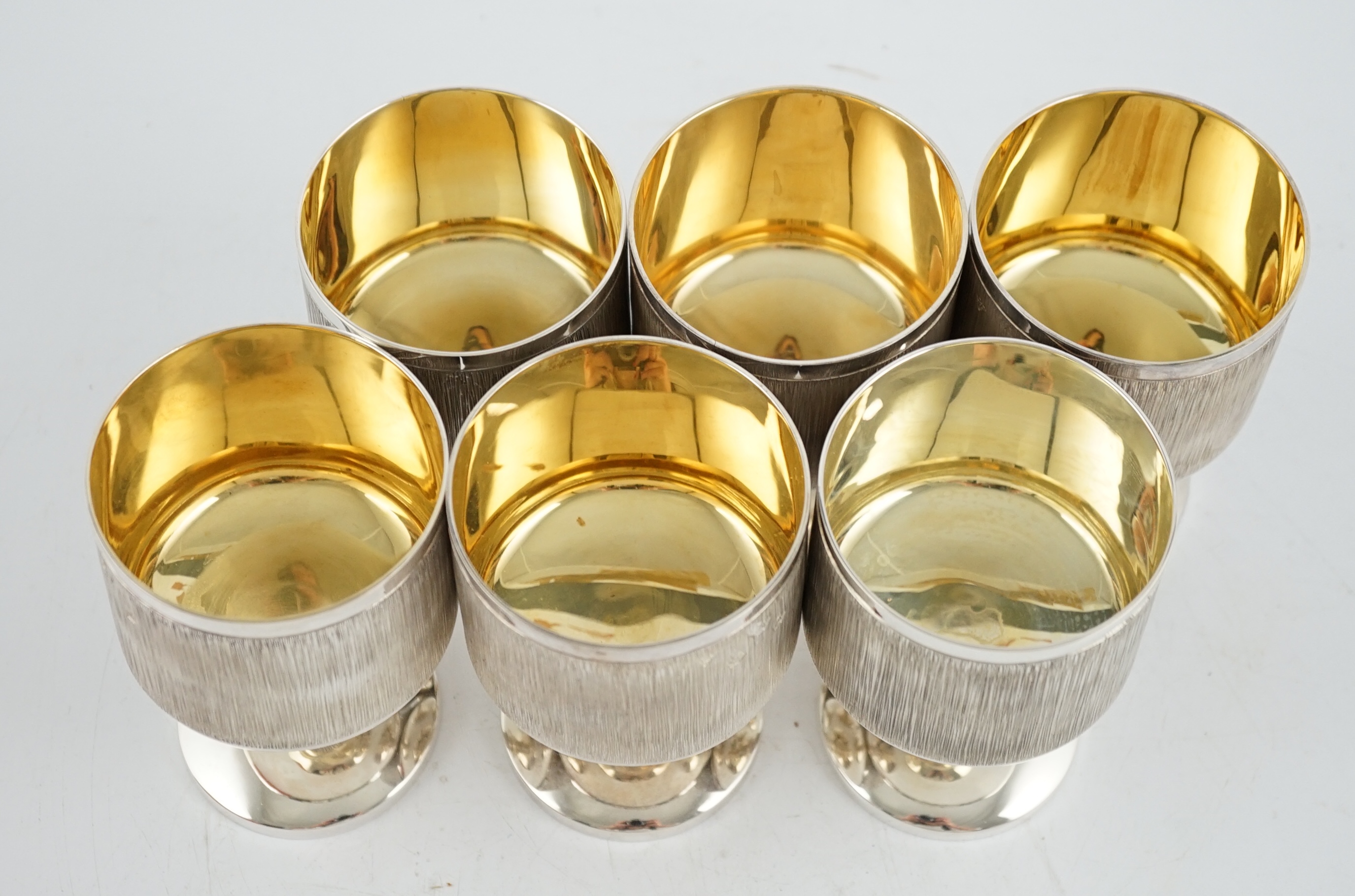 A set of six Elizabeth II textured silver pedestal goblets, by Garrard & Co Ltd